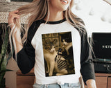 "Cat Getting Tattoo Meme" design on a white baseball raglan tee with black sleeves