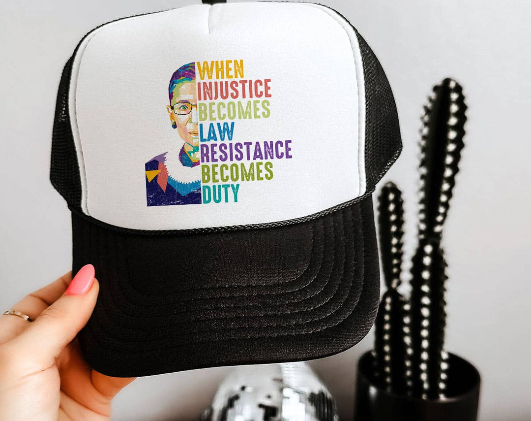"When Injustice Becomes Law RBG" design on a mesh-back snapback trucker hat