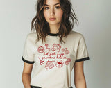 "Hot Girls Have Grandma Hobbies" design on a natural ringer t-shirt with black contrast trim