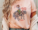 "Rootin' Tootin' Cowgirl" design on a peach unisex t-shirt