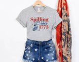 "Spilling The Tea Since 1773" design on a heather gray unisex t-shirt