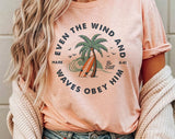 "Even The Wind & Waves Obey Him" design on a peach unisex t-shirt