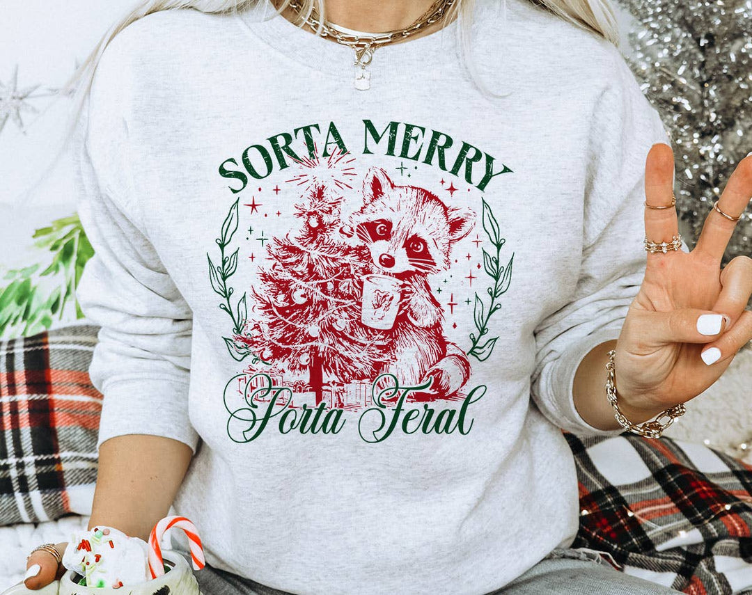 "Sorta Merry Sorta Feral" design on an ash gray unisex crewneck sweatshirt