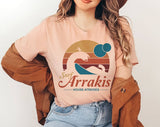"Surf Arrakis" design on a peach unisex t-shirt
