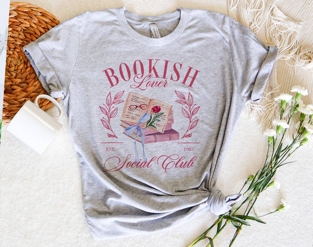 "Bookish Lovers Social Club Coquette" design on a heather gray unisex t-shirt