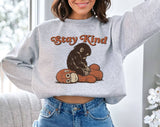 "Stay Kind Baby Punch Monkey" design on an ash gray unisex crewneck sweatshirt