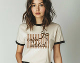 "Coffee Addict Striped Bow" design on a natural ringer t-shirt with black contrast trim