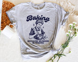 "Baking Because Murder Is Wrong" design on a heather gray unisex t-shirt