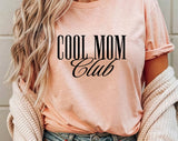 "Cool Mom Club" design on a peach unisex t-shirt