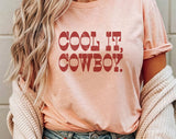 "Cool It Cowboy" design on a peach unisex t-shirt