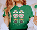 "Lucky Vibes Gold Rainbow" design on a heather green unisex t-shirt