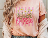 "Oopsie Daisy Striped" design on a peach unisex t-shirt