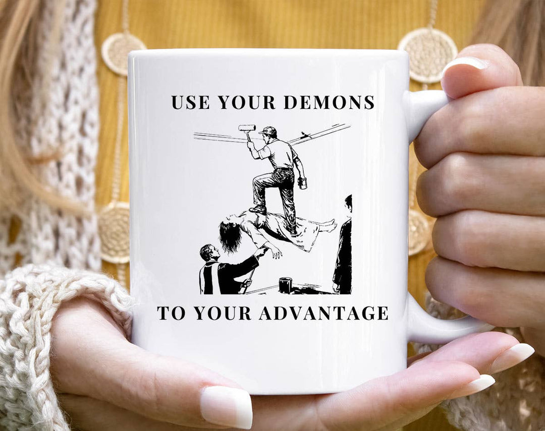 "Use Your Demons To Your Advantage" Halloween design on a white coffee mug