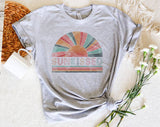 "Sunkissed Rainbow" design on a heather gray unisex t-shirt