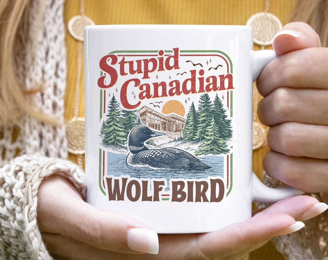 "Stupid Canadian Wolf Bird Heated Rivalry" design on a white ceramic coffee mug