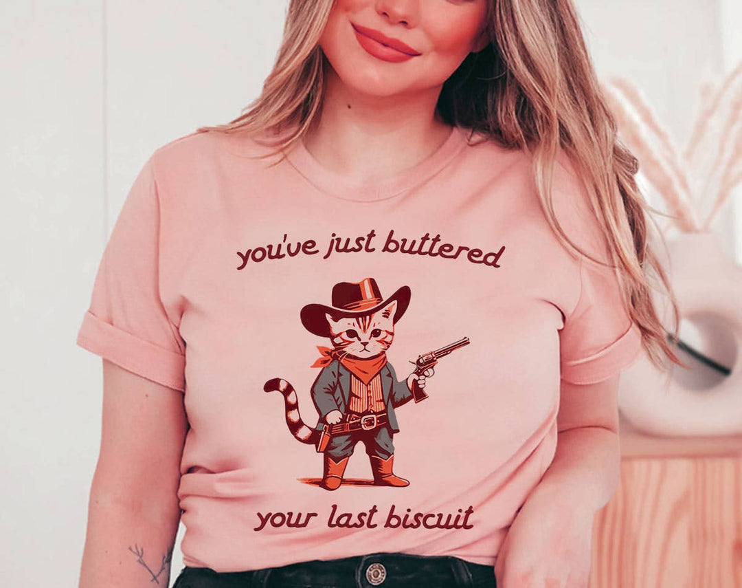 "You've Buttered Your Last Biscuit" design on a peach unisex t-shirt