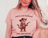 "You've Buttered Your Last Biscuit" design on a peach unisex t-shirt