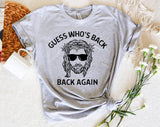 "Guess Who's Back Again Jesus" design on a heather gray unisex t-shirt