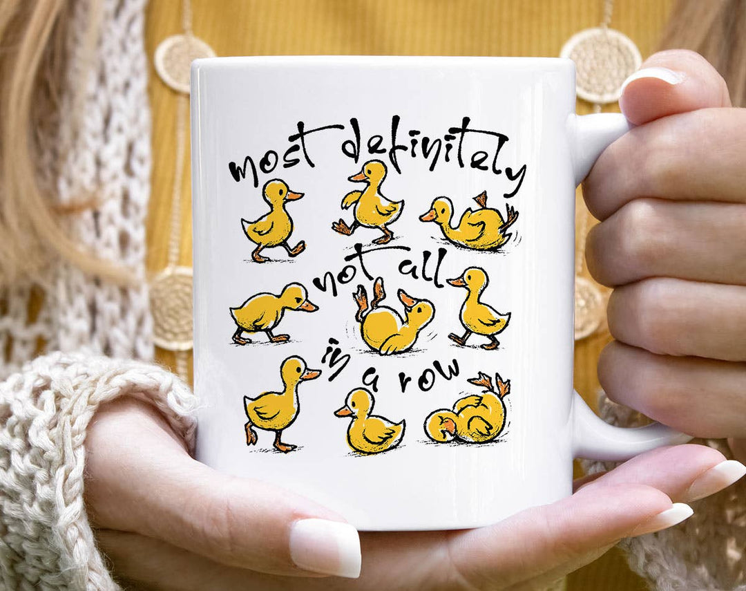 "Most Definitely Not In A Row" design on a white ceramic coffee mug