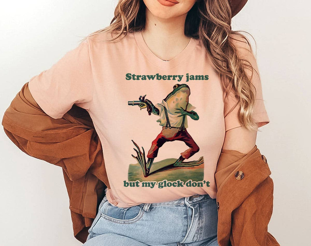 "Strawberry Jams, Glock Don't Frog Meme" design on a peach unisex t-shirt