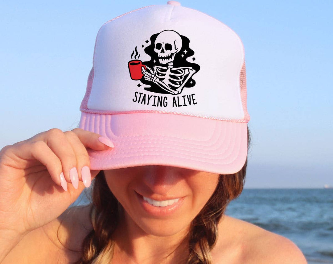 "Staying Alive Coffee Skeleton" design on a mesh-back snapback trucker hat
