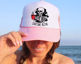 "Staying Alive Coffee Skeleton" design on a mesh-back snapback trucker hat