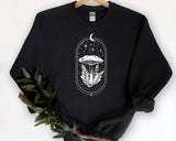 "Moon Magic Mushroom" design on a black unisex crewneck sweatshirt