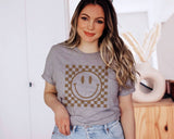 "Checkered Happy Face" design on a heather gray unisex t-shirt