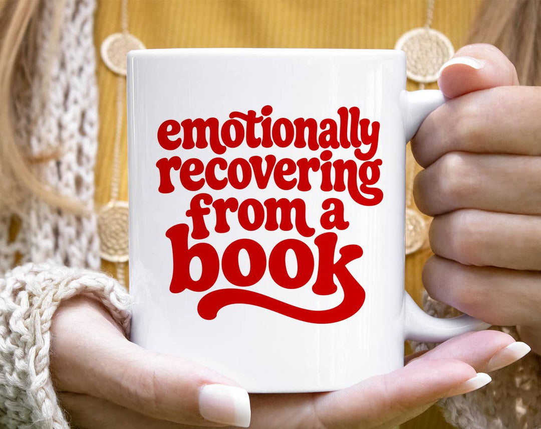 "Emotionally Recovering From A Book" design on a white ceramic coffee mug