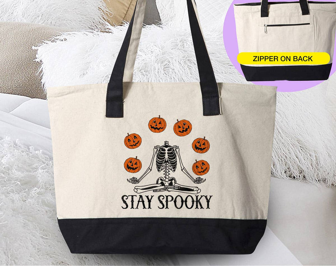 "Stay Spooky Yoga" design on a natural canvas zippered tote bag