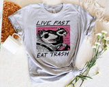"Live Fast Eat Trash Raccoon" design on a heather gray unisex t-shirt