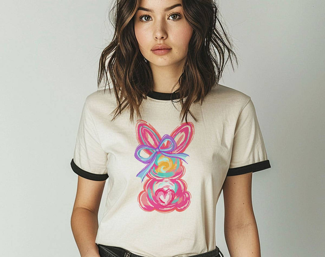 "Easter Bunny Brushstrokes" design on a natural ringer t-shirt with black contrast trim