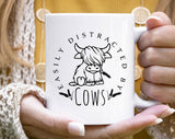 "Easily Distracted By Cows" design on a white ceramic coffee mug