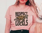 "Respect The Locals Sea Turtles" design on a peach unisex t-shirt