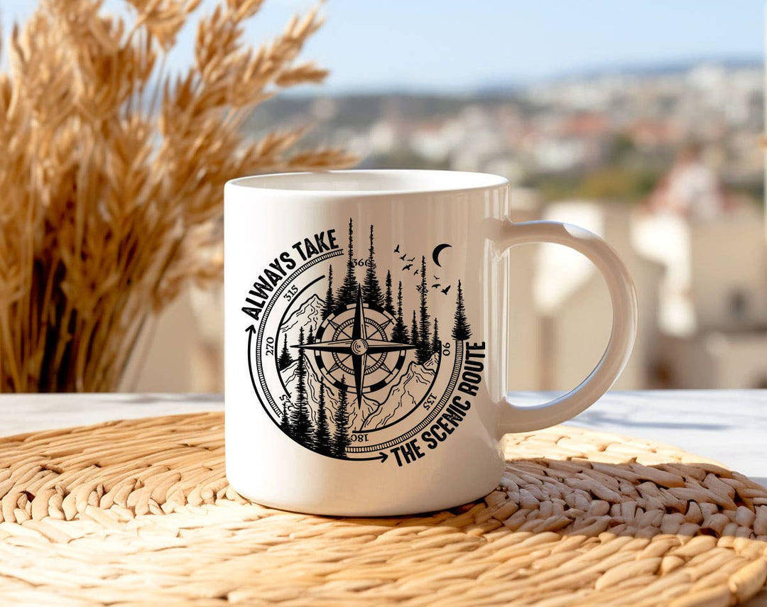 "Always Take The Scenic Route" design on a white ceramic coffee mug