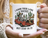 "I Know Your Lane Sucks Funny Sarcastic Skeleton" design on a white ceramic coffee mug