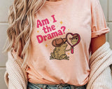 "Am I The Drama? Frog Meme" design on a peach unisex t-shirt