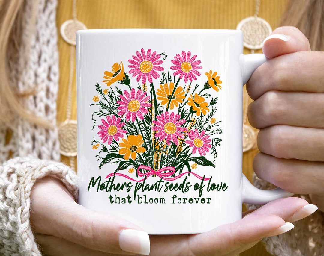 "Mothers Plant Seeds Of Love" design on a white ceramic coffee mug