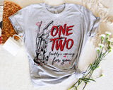 "One Two Freddy's Coming For You" design on a heather gray unisex t-shirt