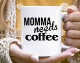 "Momma Needs Coffee" design on a white ceramic coffee mug
