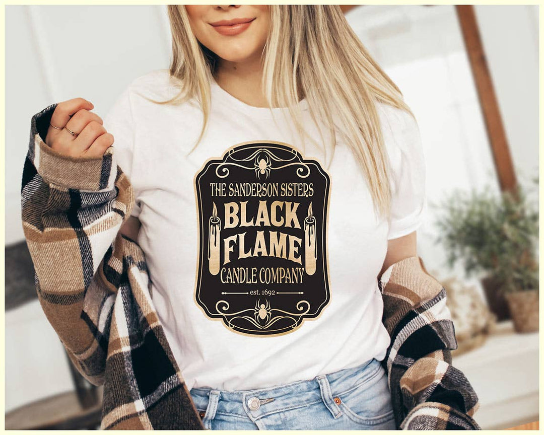 "The Black Flame Candle" design on a peach unisex t-shirt