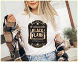 "The Black Flame Candle" design on a peach unisex t-shirt