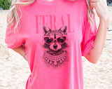"Feral Vogue Raccoon" design on a pink watermelon Comfort Colors t-shirt
