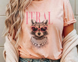 "Feral Vogue Raccoon" design on a peach unisex t-shirt