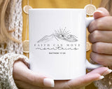 "Faith Can Move Mountains" design on a white ceramic coffee mug
