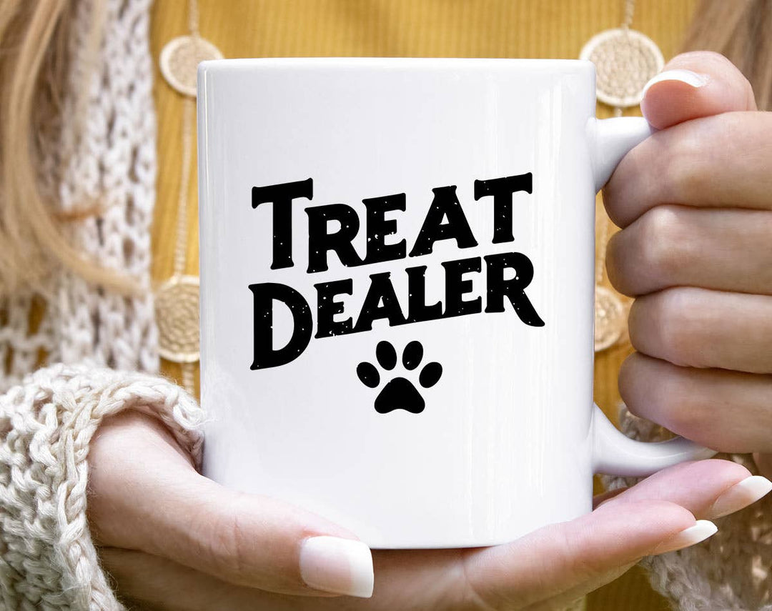 "Treat Dealer" design on a white ceramic coffee mug