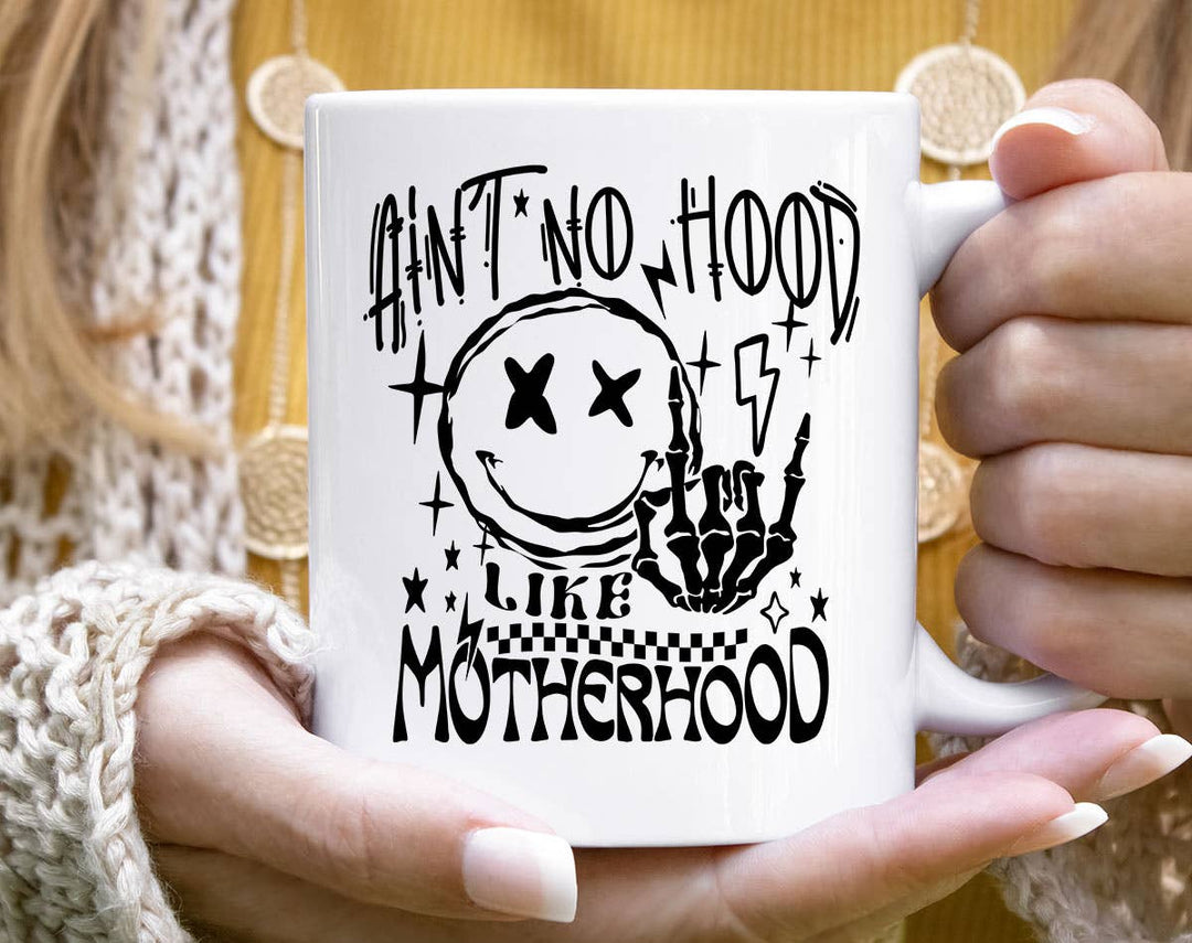 "Ain't No Hood Like Motherhood 2024" design on a white ceramic coffee mug