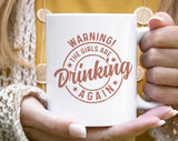 "Warning The Girls Are Drinking Again" design on a white ceramic coffee mug
