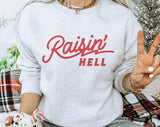 "Raisin Hell" design on an ash gray unisex crewneck sweatshirt