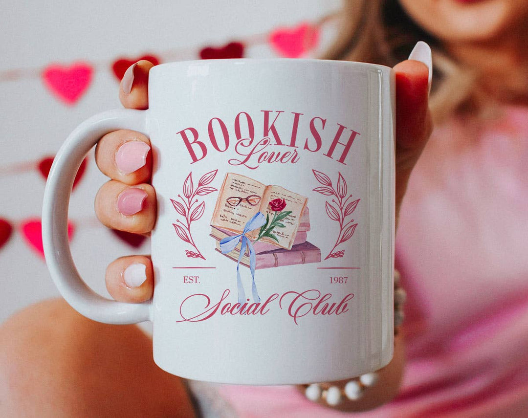 "Bookish Lovers Social Club Coquette" design on a white ceramic coffee mug